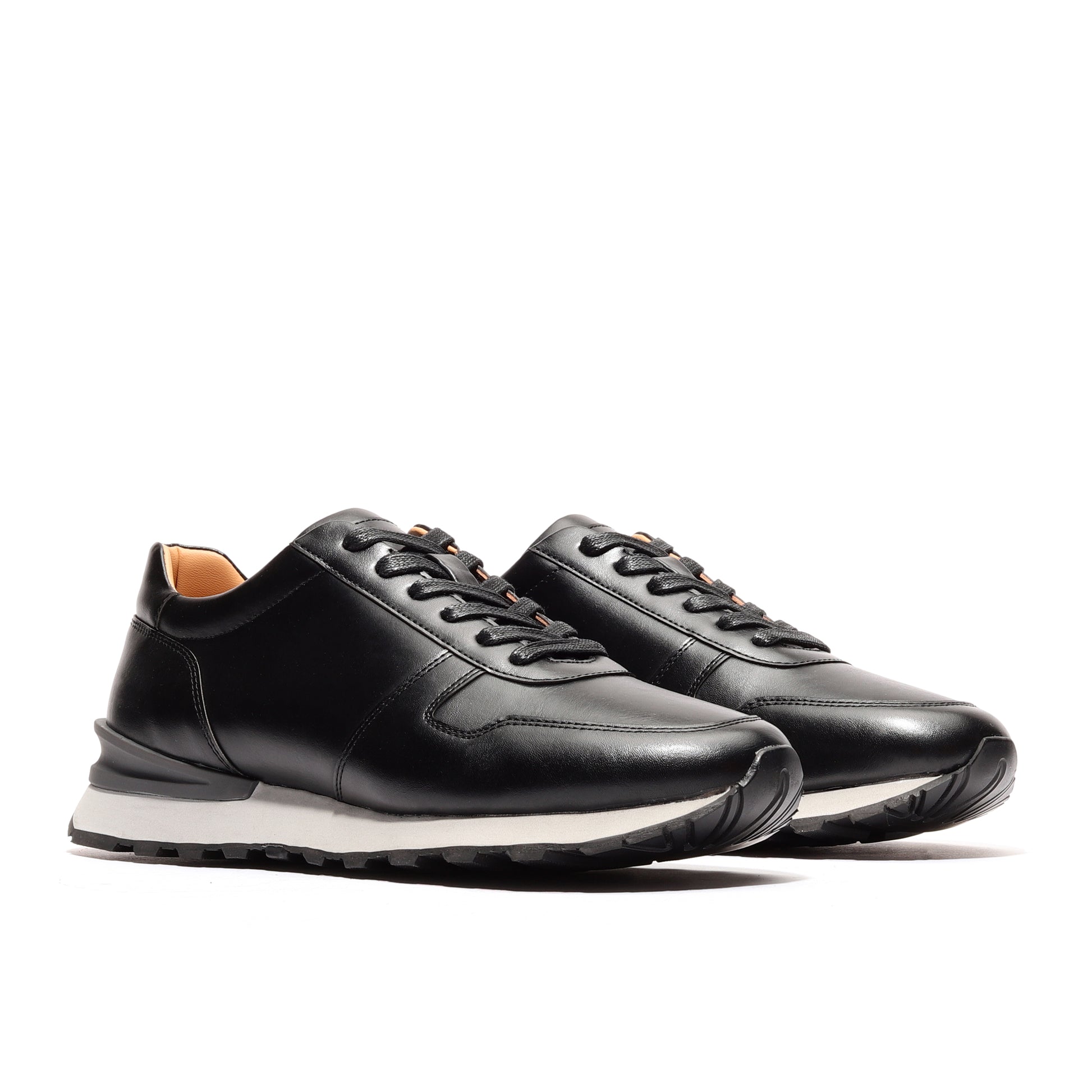 Angled view of two black athleisure shoes for men, designed as luxe runners, highlighting their stylish design and performance features ideal for workouts and casual outings.