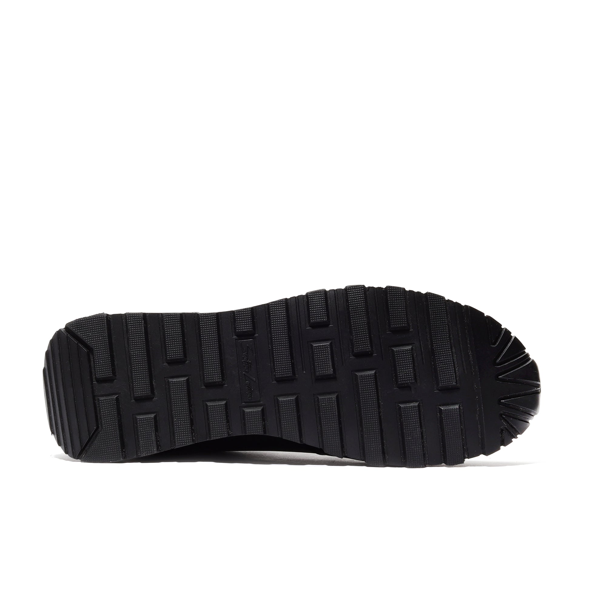 Close-up of the outsole of black performance luxe athleisure shoes, highlighting the durable traction and innovative design for enhanced grip and comfort during workouts and casual wear.